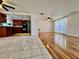 Inviting living space next to the kitchen with tile flooring and a ceiling fan at 3902 Glissade Dr, New Port Richey, FL 34652