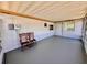 Enclosed patio with chairs, a gray floor and white walls, providing a versatile outdoor space at 3902 Glissade Dr, New Port Richey, FL 34652