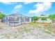 Backyard featuring a screened in pool and a large gravel area at 3928 E Eden Roc Cir, Tampa, FL 33634