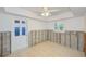 Bright bedroom with ceiling fan, window with view and easy access to a nearby entry door at 3928 E Eden Roc Cir, Tampa, FL 33634