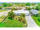 Beautiful single-story home featuring lush tropical landscaping, a metal roof and a paver driveway at 3928 E Eden Roc Cir, Tampa, FL 33634