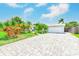 Well-manicured front yard with a long driveway and palm trees at 3928 E Eden Roc Cir, Tampa, FL 33634