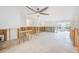 Open-concept living room with ceiling fan, lots of light and easy access to other parts of the home at 3928 E Eden Roc Cir, Tampa, FL 33634