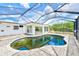 Covered pool area with screened enclosure, pool, and a large back patio at 3928 E Eden Roc Cir, Tampa, FL 33634