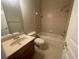 Bathroom featuring a shower-tub combo, vanity with stone countertop, and tile flooring at 405 Islebay Dr, Apollo Beach, FL 33572