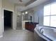 Bathroom with a large tub, separate shower, and a spacious vanity with dark cabinets at 405 Islebay Dr, Apollo Beach, FL 33572