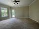 Bedroom with neutral carpet, a ceiling fan, and a door leading to the outside at 405 Islebay Dr, Apollo Beach, FL 33572