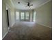Spacious bedroom with neutral carpet, multiple windows, and a ceiling fan at 405 Islebay Dr, Apollo Beach, FL 33572
