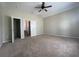 Bedroom featuring neutral carpet, ceiling fan, and multiple doorways at 405 Islebay Dr, Apollo Beach, FL 33572