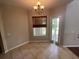 Bright dining area features tile flooring, a window, and a stylish chandelier at 405 Islebay Dr, Apollo Beach, FL 33572