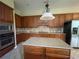 Functional kitchen with dark wood cabinets, granite countertops, center island, and stainless steel appliances at 405 Islebay Dr, Apollo Beach, FL 33572