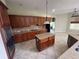 Well-equipped kitchen with dark cabinetry, granite countertops, stainless steel appliances, and center island at 405 Islebay Dr, Apollo Beach, FL 33572