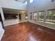 Spacious open-concept living room with hardwood floors, high ceilings, and seamless flow to the kitchen and dining area at 405 Islebay Dr, Apollo Beach, FL 33572