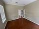 Well-lit living room with hardwood flooring and french doors leading to other rooms at 405 Islebay Dr, Apollo Beach, FL 33572