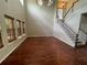 Bright living room with tall ceilings, hardwood floors, natural window coverings, and a staircase at 405 Islebay Dr, Apollo Beach, FL 33572