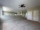 Living area featuring neutral carpet, and view of the second story, with lots of natural light at 405 Islebay Dr, Apollo Beach, FL 33572