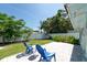 Landscaped backyard featuring a patio, lush green lawn, garden, and a white privacy fence at 4718 24Th S Ave, St Petersburg, FL 33711