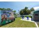 Backyard featuring a shed with mural, an outdoor shower, and lush tropical landscaping at 4718 24Th S Ave, St Petersburg, FL 33711