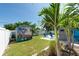 Backyard featuring a shed with mural, an outdoor shower, and lush tropical landscaping at 4718 24Th S Ave, St Petersburg, FL 33711