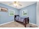 Comfortable bedroom featuring wood-look floors and two windows, with a traditional-style bed at 4718 24Th S Ave, St Petersburg, FL 33711