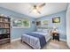 Cozy bedroom with serene blue walls, ceiling fan, and ample natural light at 4718 24Th S Ave, St Petersburg, FL 33711