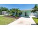 Light-blue home with a well-maintained yard, new landscaping, and a covered driveway at 4718 24Th S Ave, St Petersburg, FL 33711