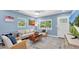 Cozy living room with comfortable seating, light-blue walls, stylish decor, and abundant natural light at 4718 24Th S Ave, St Petersburg, FL 33711