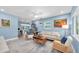 Open-concept living room with light-blue walls, comfortable seating, and a stylish workspace at 4718 24Th S Ave, St Petersburg, FL 33711