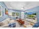 Inviting living room features neutral furniture, blue accents, and a large window showcasing the neighborhood at 4718 24Th S Ave, St Petersburg, FL 33711