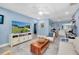 Well-lit living room boasts natural light, cozy seating, and an adjacent workstation for modern living at 4718 24Th S Ave, St Petersburg, FL 33711