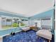 Bright sunroom with large windows, chaise lounges, and a telescope at 4718 24Th S Ave, St Petersburg, FL 33711