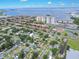 An aerial view of a charming neighborhood featuring mature trees and glimpses of the waterfront in the distance at 4731 W Leila Ave, Tampa, FL 33616