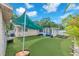 This backyard has artificial turf and a shade at 4731 W Leila Ave, Tampa, FL 33616