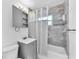 Updated bathroom with a shower-tub combination, gray vanity, tile surround, and modern fixtures at 4731 W Leila Ave, Tampa, FL 33616