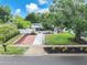 The front exterior features green grass and an inviting walkway at 4731 W Leila Ave, Tampa, FL 33616