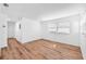 Bright living room features hardwood floors, white walls, and windows allowing ample natural light at 4731 W Leila Ave, Tampa, FL 33616