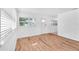 Bright living room with wood floors, white walls, and windows allowing ample natural light at 4731 W Leila Ave, Tampa, FL 33616