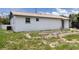 Rear view of the house exhibiting fresh paint, a well-maintained yard, and a serene outdoor atmosphere at 4823 Ashland Dr, Tampa, FL 33610