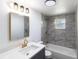 Stylish bathroom with a white countertop, gray vanity, marble tile, and gold fixtures providing a modern, luxurious feel at 4823 Ashland Dr, Tampa, FL 33610