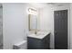 Updated bathroom with gray vanity, modern sink, gold fixtures, and white wall at 4823 Ashland Dr, Tampa, FL 33610