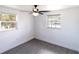 Bright empty bedroom with a ceiling fan and two windows at 4823 Ashland Dr, Tampa, FL 33610