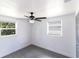 Empty bedroom featuring a ceiling fan and two windows at 4823 Ashland Dr, Tampa, FL 33610