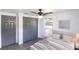 Bright bedroom with gray accents, ceiling fan, and large closet at 4823 Ashland Dr, Tampa, FL 33610