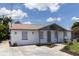 Side angle of a single-story home featuring fresh exterior paint, manicured lawn, and great curb appeal at 4823 Ashland Dr, Tampa, FL 33610