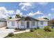 Beautiful single-story home featuring fresh exterior paint, landscaping and covered porch at 4823 Ashland Dr, Tampa, FL 33610