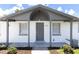 Charming single-story home with a covered porch and freshly painted in bright white at 4823 Ashland Dr, Tampa, FL 33610