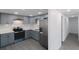 Modern kitchen featuring gray cabinets, stainless steel appliances, and white countertops at 4823 Ashland Dr, Tampa, FL 33610
