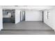 Open floor plan with grey floors connecting the living area, kitchen, and dining space at 4823 Ashland Dr, Tampa, FL 33610