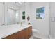 Bathroom featuring a sleek vanity with modern fixtures and a glass-enclosed shower at 503 W Davis Blvd, Tampa, FL 33606