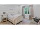Charming bedroom with decorative wall paneling and matching curtains framing the window at 503 W Davis Blvd, Tampa, FL 33606